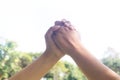 Hands hit and bumping together with sun light on grass background Royalty Free Stock Photo