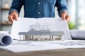 Architect Reviewing Modern House Design with Model and Blueprints Royalty Free Stock Photo