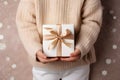 Hands hold a beautiful gift box with a ribbon and white tulips, Gift Giving, Surprise Gift - Ai Generated