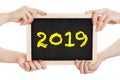 Hands hold chalkboard for the new year 2019 - isolated on white background Royalty Free Stock Photo
