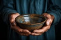 Hands hold empty bowl, portraying the harshness of hunger and economic hardship Royalty Free Stock Photo