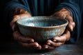 Hands hold empty bowl, portraying the harshness of hunger and economic hardship Royalty Free Stock Photo