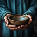 Hands hold empty bowl, portraying the harshness of hunger and economic hardship Royalty Free Stock Photo