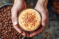 Hands hold freshly brewed cappuccino, sprinkled with chocolate shavings on foam Royalty Free Stock Photo