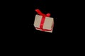 Hands hold gift box with red ribbon, copy space isolated on black. Sales concepts, discount price, christmas gifts Royalty Free Stock Photo