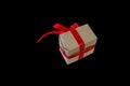 Hands hold gift box with red ribbon, copy space isolated on black. Sales concepts, discount price, christmas gifts Royalty Free Stock Photo