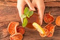 Hands hold a glass of Bael fruit Tea Royalty Free Stock Photo