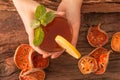 Hands hold a glass of Bael fruit Tea Royalty Free Stock Photo