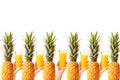 Hands hold glasses of fresh pineapple juice near ripe pineapple against white background Royalty Free Stock Photo