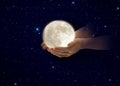 Hands hold moon on front on starry sky night cosmic univerce keep the peace concep