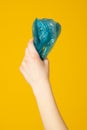 Hands hold recycling plastic bag isolated on yellow background. Stop nature garbage, ecology environment protection Royalty Free Stock Photo