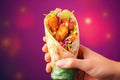 Hands hold Shawarma. Meat, vegetables and salad are wrapped in pita bread. Side view Royalty Free Stock Photo