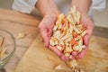 Hands hold sliced apples in handfuls. Adult woman cook a pie on the kitchen table Royalty Free Stock Photo