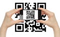 Hands hold smart phone with QR code Royalty Free Stock Photo