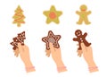 Hands hold traditional xmas cookies symbols: gingerbread, tree