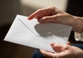 Hands hold a white envelope. The envelope is plain, with a traditional triangular flap. Th Royalty Free Stock Photo