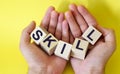 Hands hold  blocks with the word Skill, Royalty Free Stock Photo