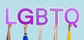 Hands holding the abbreviation LGBTQ