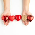 Hands holding assorted heart-shaped objects Royalty Free Stock Photo