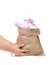Hands holding bag full with euro bills. Royalty Free Stock Photo