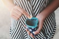 Hands holding bank coins and small money pouch Royalty Free Stock Photo