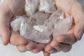 Hands holding beautiful quartz clusters