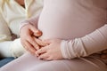 Hands holding belly of a pregnant woman Royalty Free Stock Photo