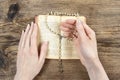 Hands holding the Bible and praying with a rosary Royalty Free Stock Photo