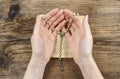 Hands holding the Bible and praying with a rosary Royalty Free Stock Photo