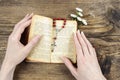 Hands holding the Bible and praying with a rosary Royalty Free Stock Photo