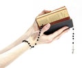 Hands holding the Bible and praying with a rosary Royalty Free Stock Photo