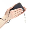 Hands holding the Bible and praying with a rosary Royalty Free Stock Photo