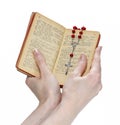 Hands holding the Bible and praying with a rosary Royalty Free Stock Photo