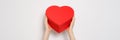 Hands holding big red box in shape of a heart. Trendy video banner for Valentines Day, International Womens Day or Royalty Free Stock Photo