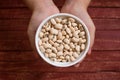 Hands holding black eyed beans in white bowl Royalty Free Stock Photo