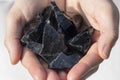 Hands holding Black Obsidian Royalty Free Stock Photo