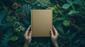 Hands Holding Blank Book In Green Forest Royalty Free Stock Photo