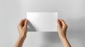 Hands Holding Blank Paper on Neutral Background Royalty Free Stock Photo