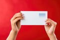 Hands holding blank paper on red background, mockup for design, Empty card in woman hand. Copy space. American flag background, AI Royalty Free Stock Photo