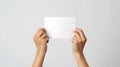 Hands Holding Blank Paper on White Background Royalty Free Stock Photo