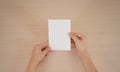 Hands holding blank white brochure booklet in the hand. Leaflet Royalty Free Stock Photo