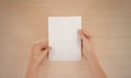 Hands holding blank white brochure booklet in the hand. Leaflet Royalty Free Stock Photo