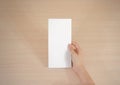 Hands holding blank white brochure booklet in the hand. Leaflet Royalty Free Stock Photo