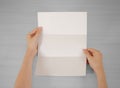 Hands holding blank white brochure booklet in the hand. Leaflet Royalty Free Stock Photo