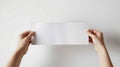 Hands Holding Blank White Paper on White Background Royalty Free Stock Photo