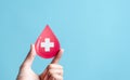 hands holding blood drop paper cut, blood transfusion, world blood donor day, red cross to give blood.world hemophilia day concept Royalty Free Stock Photo