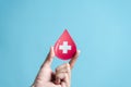 hands holding blood drop paper cut, blood transfusion, world blood donor day, red cross to give blood.world hemophilia day concept Royalty Free Stock Photo