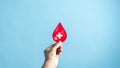 Hands holding blood drop paper cut, blood transfusion, world blood donor day Royalty Free Stock Photo