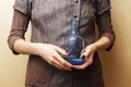 Hands holding blue bottle
