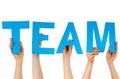 Hands holding blue letters building team Royalty Free Stock Photo